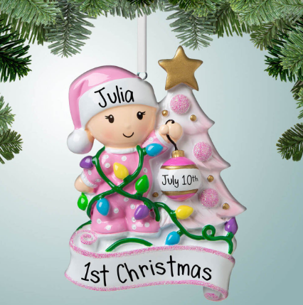 new baby girl decorating tree ornament